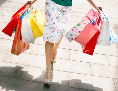 Woman with shopping bags walking down the street