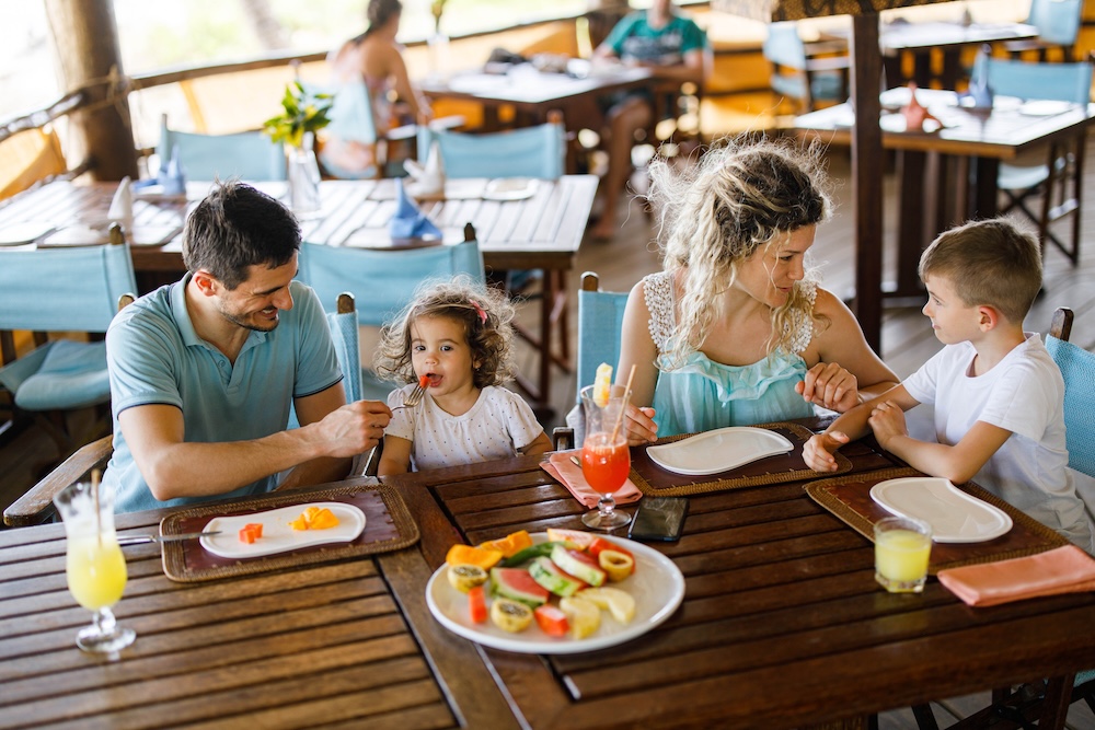 family out to breakfast at a beach restaurant